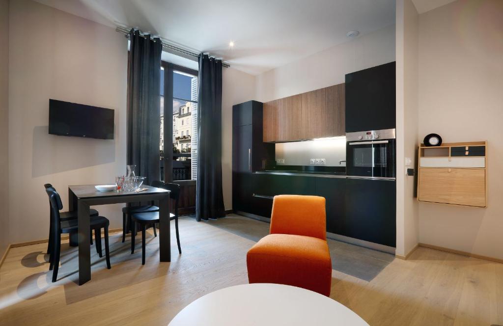a kitchen and dining room with a table and chairs at Villa Saint Enogat in Aix-les-Bains