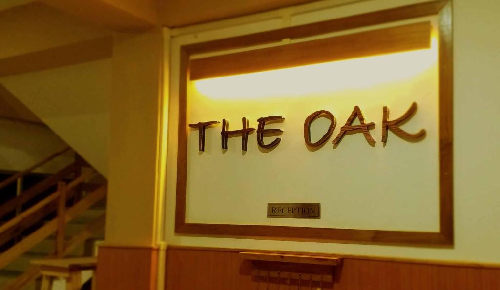 a window with the oak written on it at Hotel The Oak in Tawang
