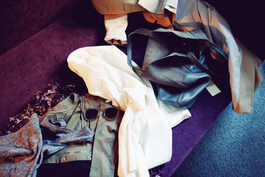 a pile of clothes and sunglasses on the floor at Saint SHERMIN bed breakfast & champagne in Vienna