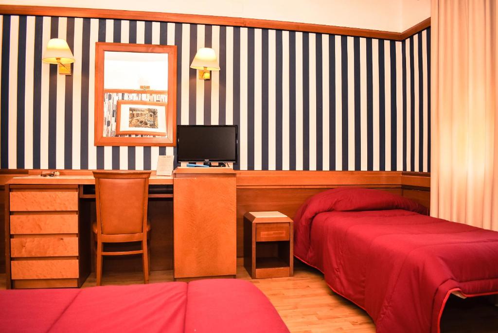Postel nebo postele na pokoji v ubytování Hotel Miravalle