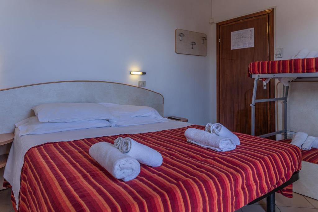 Postel nebo postele na pokoji v ubytování Hotel Beverly
