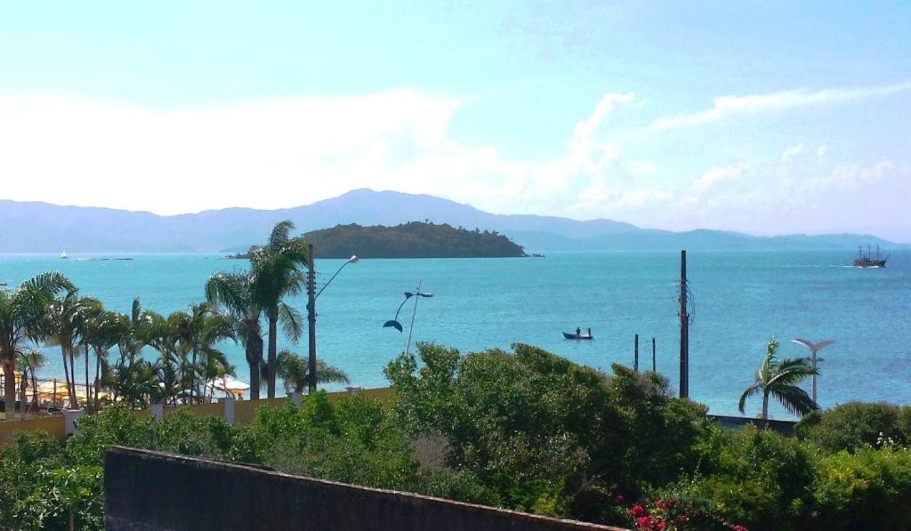 a view of the ocean with mountains in the background at Lexus Residence 210 in Florianópolis
