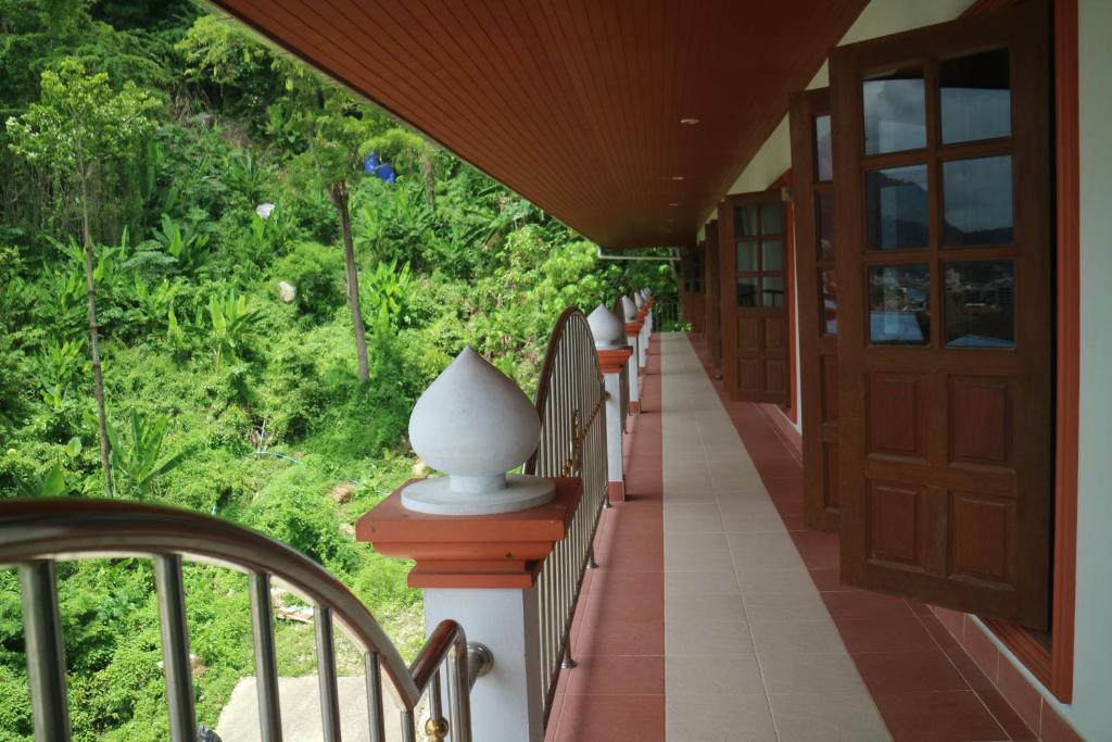 a porch with a white vase sitting on top of it at Grand View in Patong Beach
