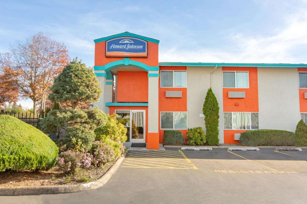 a hotel with a parking lot in front of it at Howard Johnson by Wyndham Salem in Salem