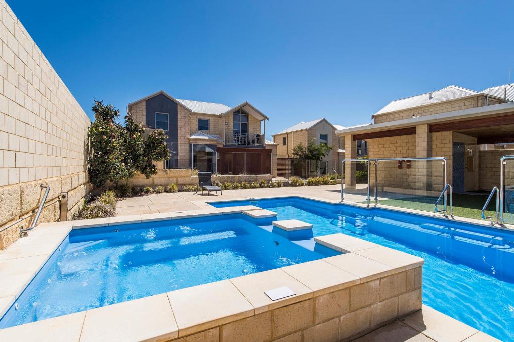 a large swimming pool in front of a building at Serenity on the Terrace in Mandurah