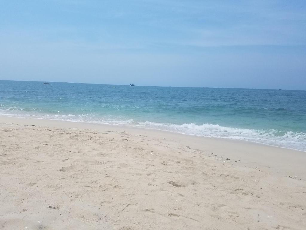 a sandy beach with the ocean in the background at Khách sạn Cà Ná in Phan Rang