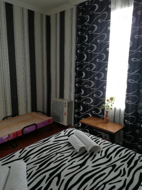 Postel nebo postele na pokoji v ubytování Nikoloz Guesthouse