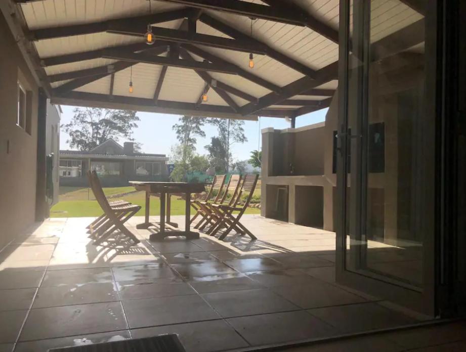 a patio with chairs and a table on a patio at Silver Pond Lodge in Robertson