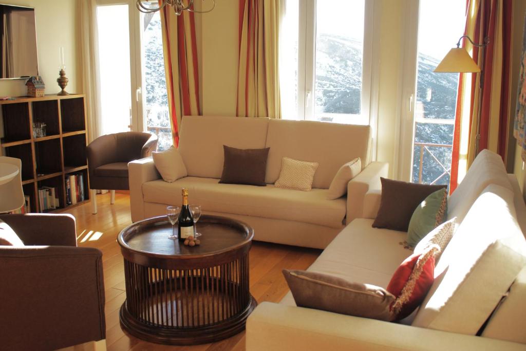 ein Wohnzimmer mit Sofas und einem Tisch in der Unterkunft Miramar Ski a pie de pista - Apartamento Deluxe, 4 habitaciones in Sierra Nevada