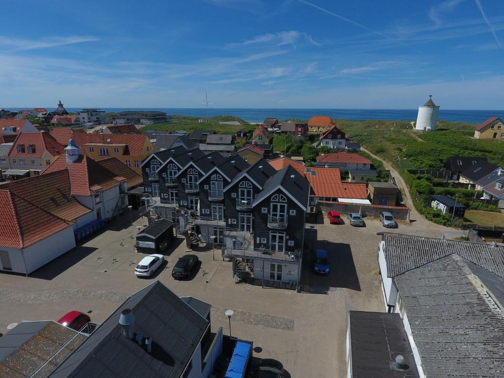 an aerial view of a town with houses and the ocean at Luksus i Løkken in Løkken