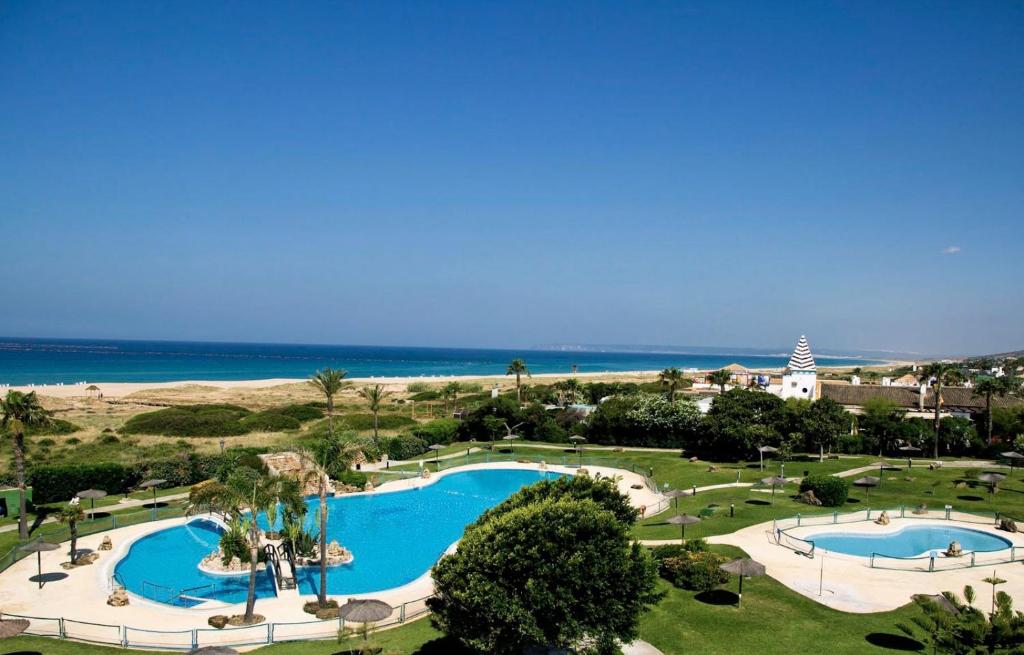 an aerial view of a resort with two swimming pools at ATICO DUPLEX APARTAMENTO ATLANTERRA PLAYA, ZAHARA DE LOS ATUNES in Zahara de los Atunes