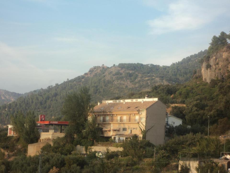 a large building in front of a mountain at Hotel San Julian in Burunchel