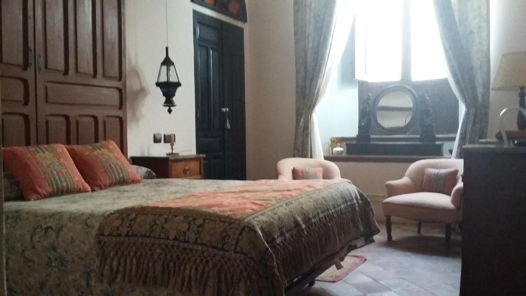 En eller flere senger på et rom på Hotel Ordóñez Sandoval