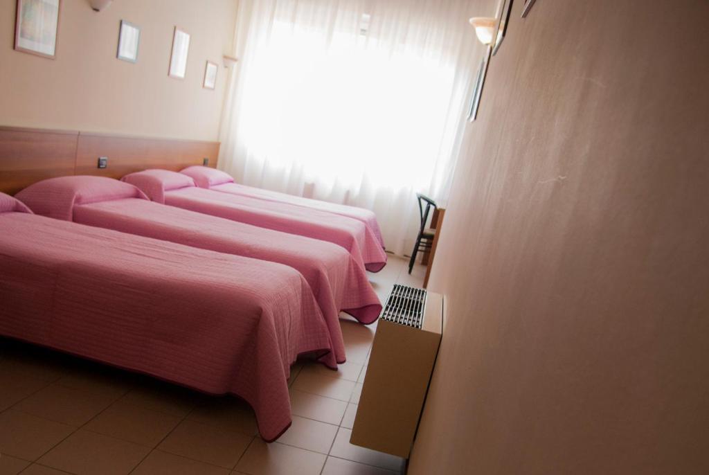 Postel nebo postele na pokoji v ubytování Hotel Marinoni
