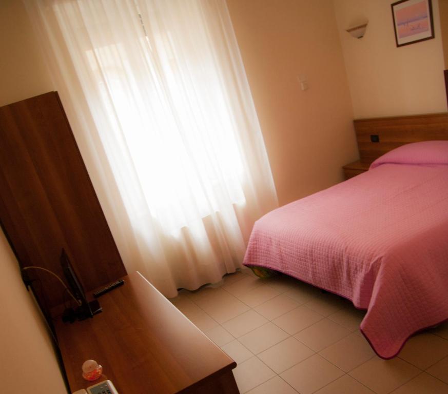 Postel nebo postele na pokoji v ubytování Hotel Marinoni