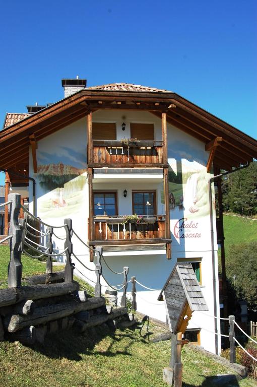 a building with a staircase in front of it at Chalet alla Cascata in Badia