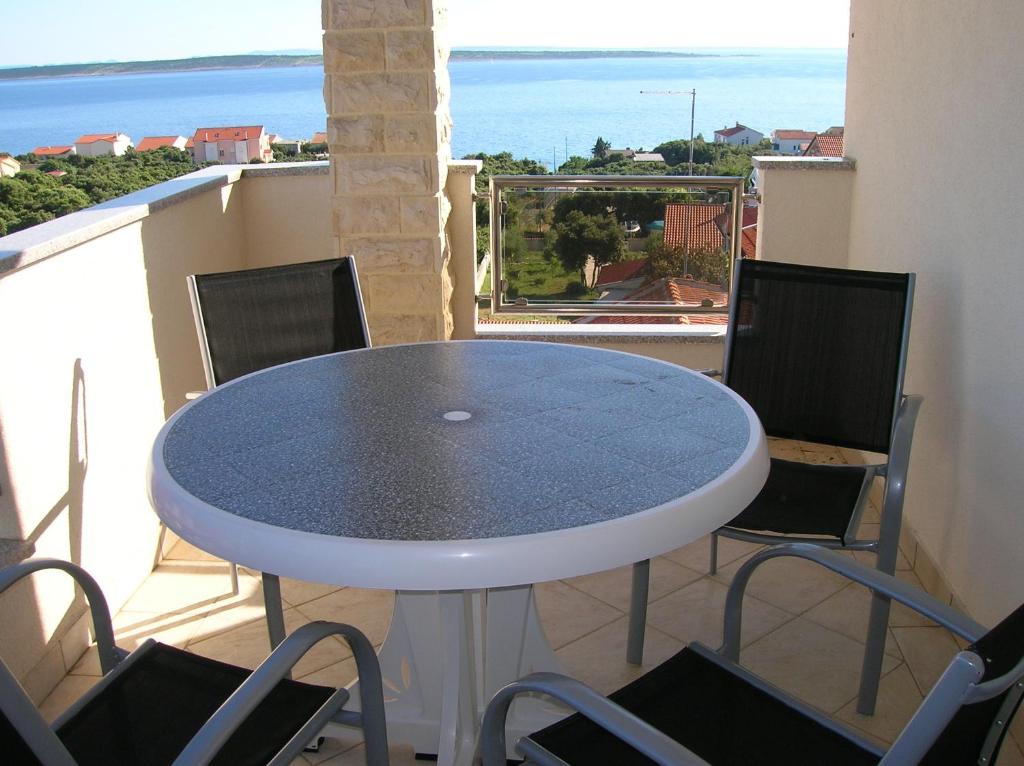 a blue table on a balcony with chairs at Apartments Sanmar in Mandre