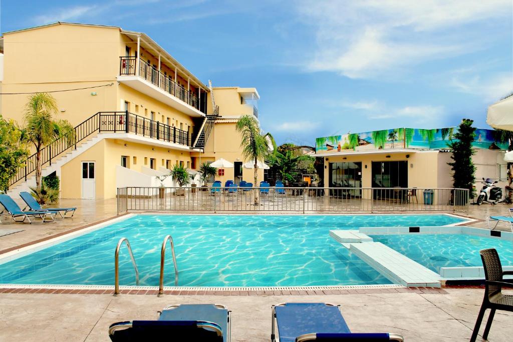 a swimming pool in front of a hotel at La caretta hotel in Alikanas