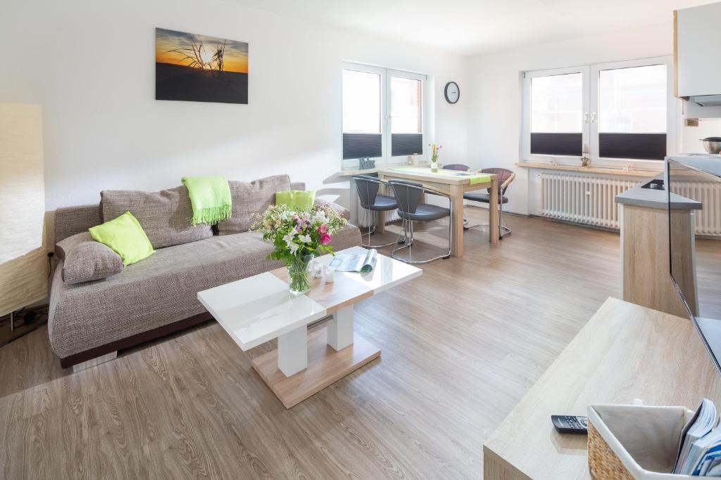 a living room with a couch and a table at Ferienhaus an der Karlstraße in Norderney