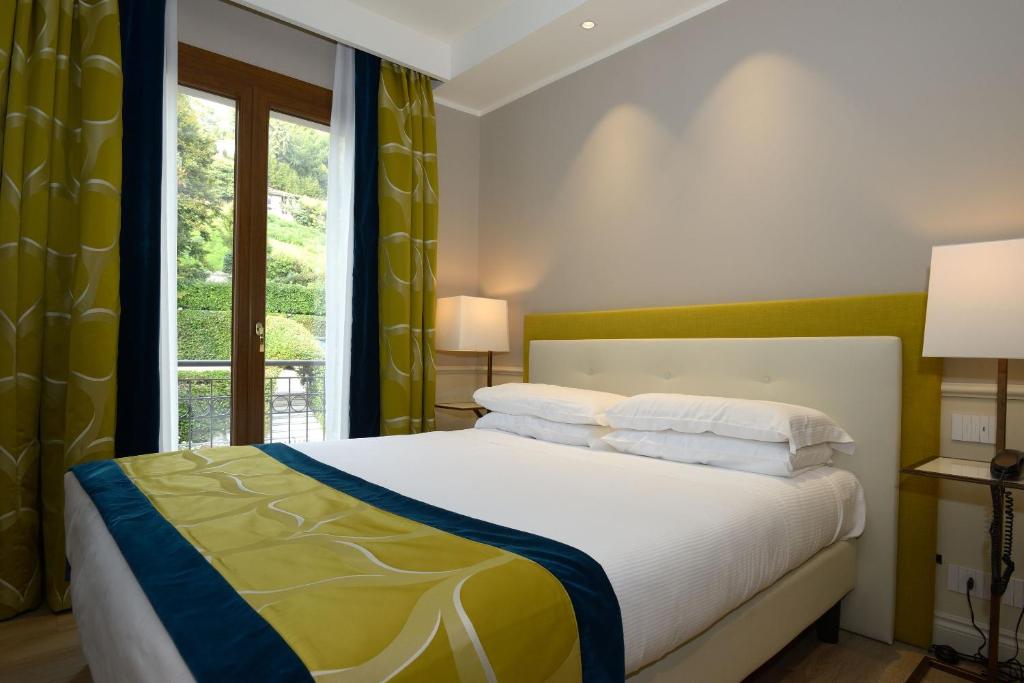 Postel nebo postele na pokoji v ubytování Hotel Canon d'Oro