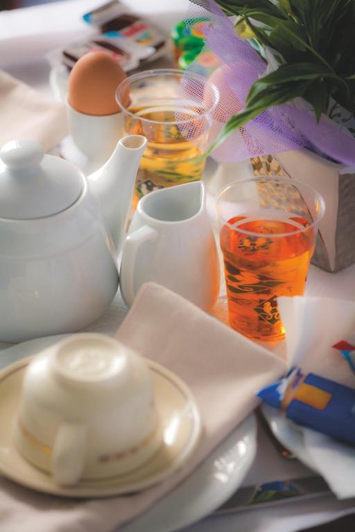a table with plates and cups and a tea pot at Hotel Voce del Mare in Vietri sul Mare