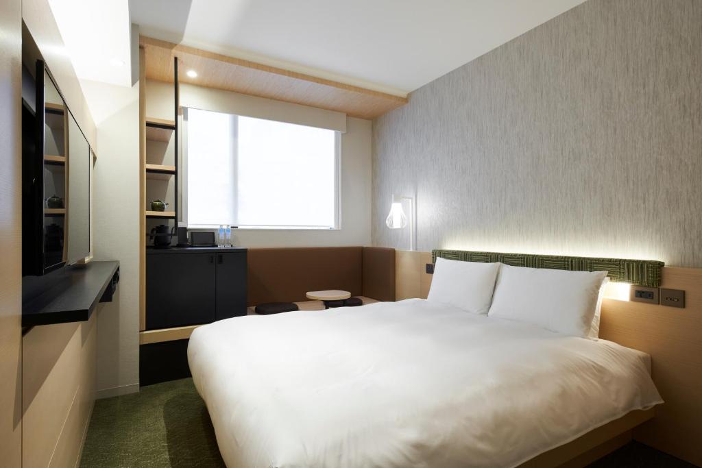 Postel nebo postele na pokoji v ubytování HOTEL 1899 TOKYO