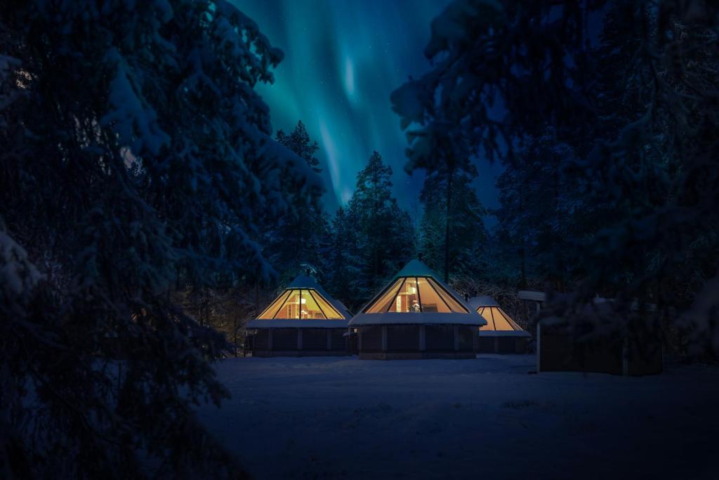 a night time picture of a house with the lights on at Pyhän Asteli Aurora Igloos & Suites in Pyhätunturi