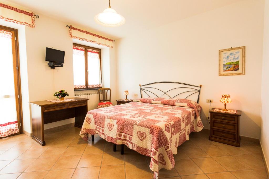 Postel nebo postele na pokoji v ubytování Agriturismo Daniela