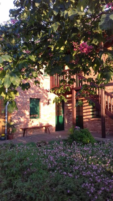 a bench in front of a brick building with flowers at KASTANIENHOF I in Burg