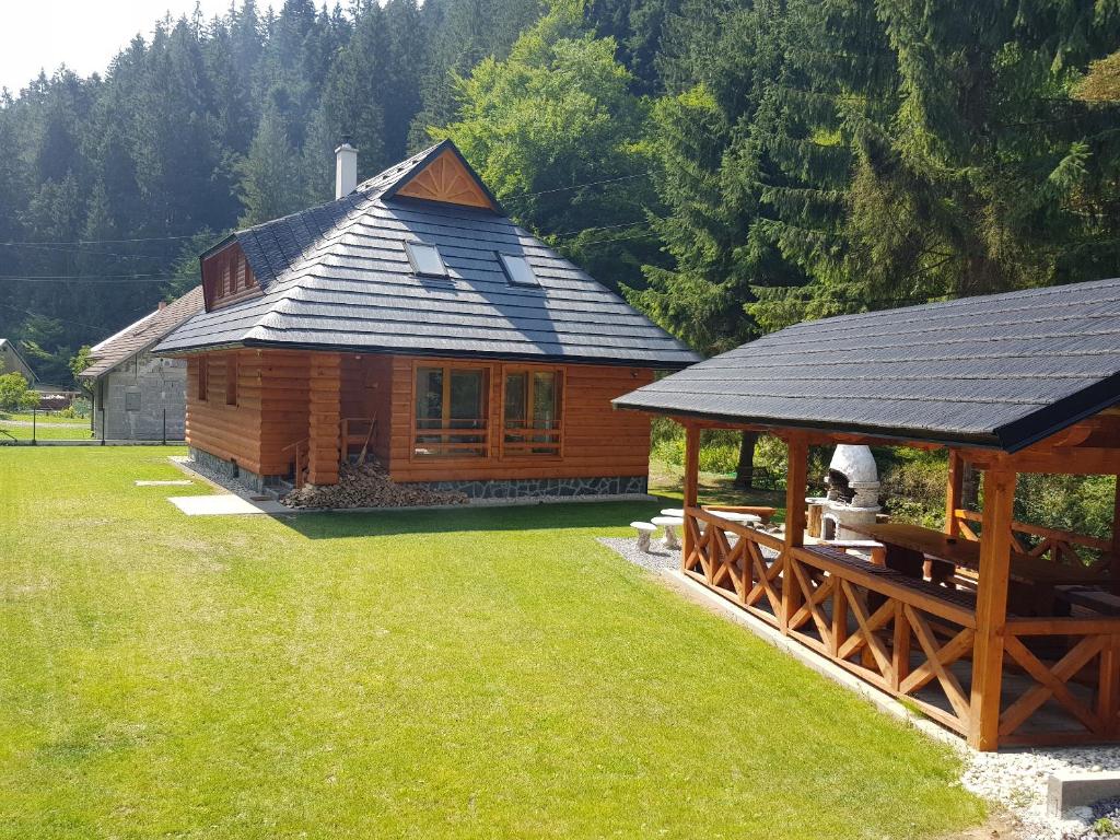 a log cabin with a gazebo in a yard at Chata Romeo in Harmanec