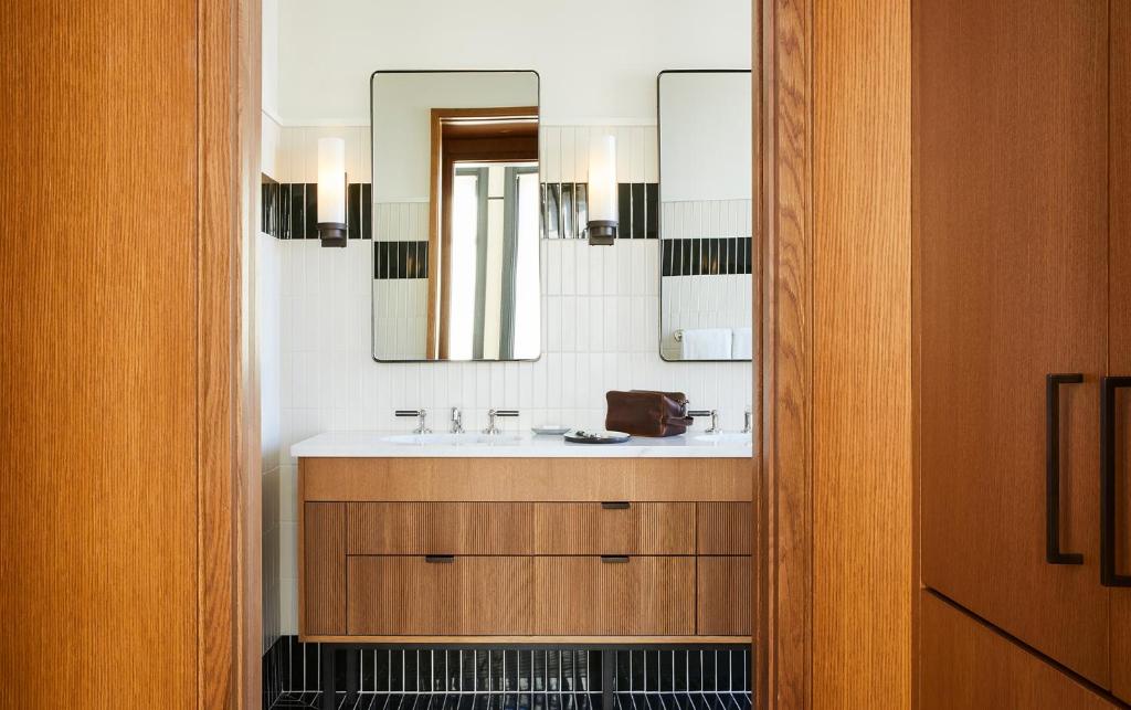 a bathroom with a sink and a mirror at Shinola Hotel in Detroit