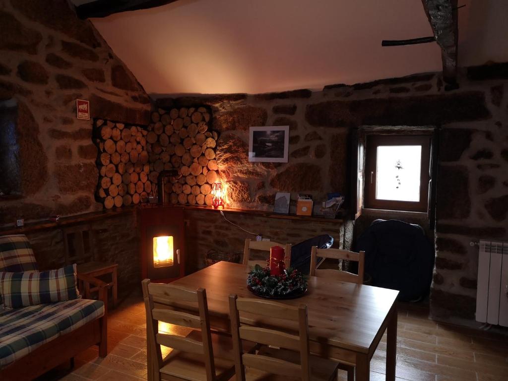 a dining room with a table and chairs and a window at Casa da Avó Ana Alvão in Bilhó