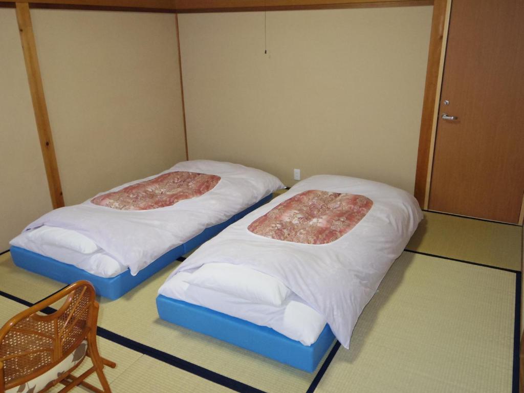 Postel nebo postele na pokoji v ubytování Guest House Motomiya