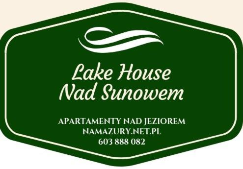 ein grünes Label für ein Seehaus nadswowerarma istg istg istg istg istg in der Unterkunft Nad Sunowem Lake House in Chrzanowo