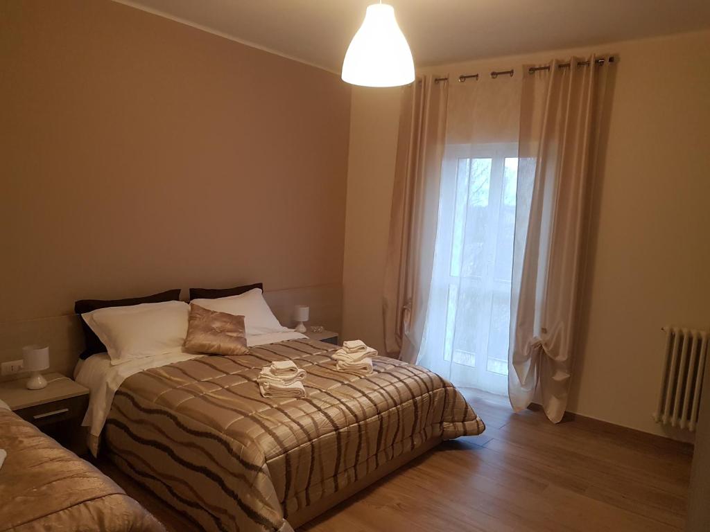 a bedroom with a bed and a large window at Casa Vacanze Derica in Matera