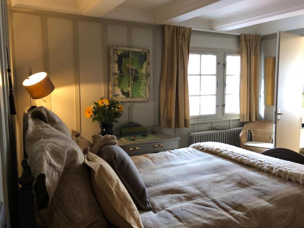 a bedroom with a large bed and a lamp at Good4Yew BnB in Zurich