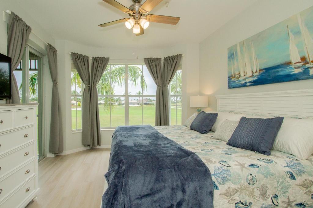 a bedroom with a bed and a ceiling fan at GreenLinks Golf View Villa Mustang at Lely Resort in Naples