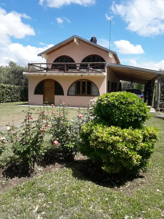 a house with two bushes in front of it at Habitación casa de campo. in San Rafael