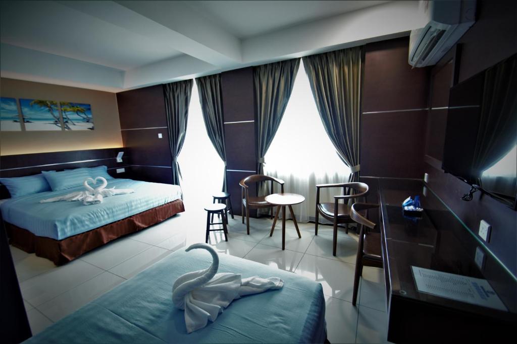 Postel nebo postele na pokoji v ubytování Wave View Hotel