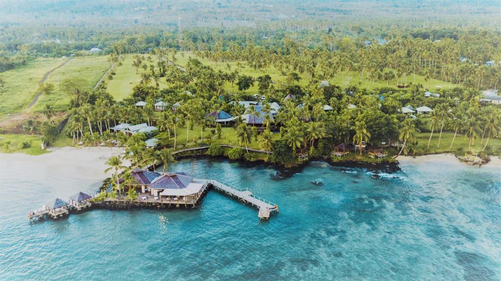 an aerial view of a resort on an island in the water at Sinalei Reef Resort & Spa in Maninoa