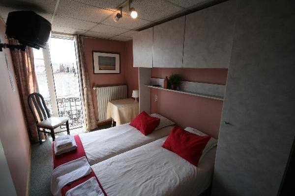 Postel nebo postele na pokoji v ubytování Hotel Anvers