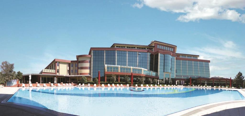 a large building with a large swimming pool in front of it at Marma Hotel Istanbul Asia in Istanbul