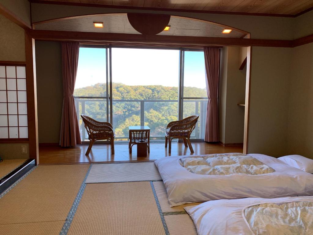 Postel nebo postele na pokoji v ubytování Manazuru Marin Hotel