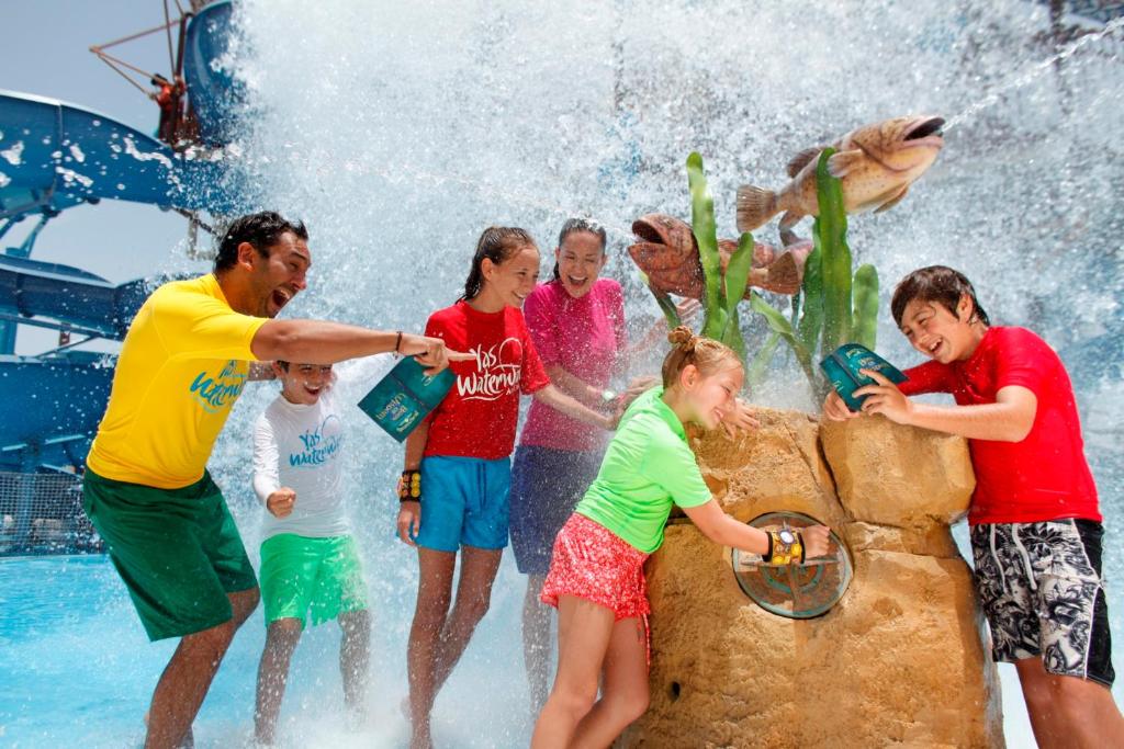 a group of people playing in a water park at Yas Island Rotana Abu Dhabi in Abu Dhabi