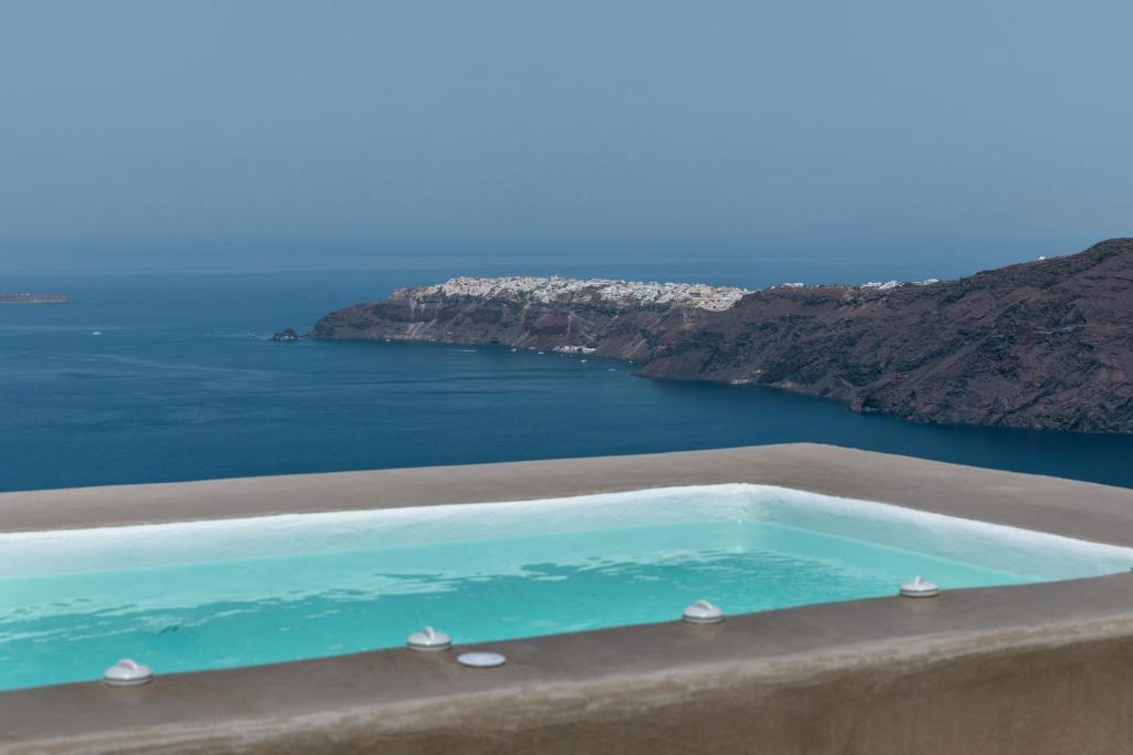 a swimming pool with a view of the ocean at The 360° Caldera view house by Caldera Houses in Imerovigli