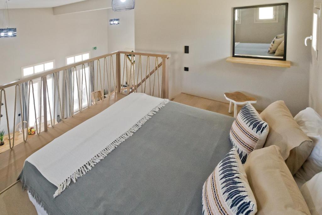 a living room with a couch and a mirror at Kalimera Karpathos Exclusive Villas in Afiartis