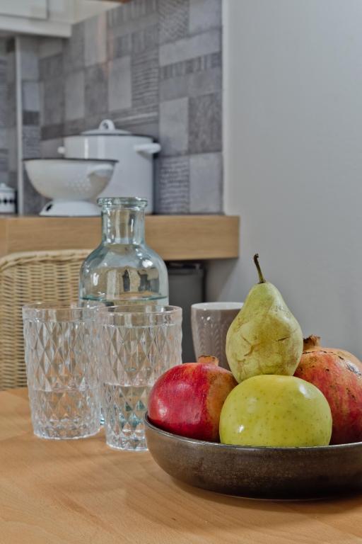 a bowl of apples and pears on a table at Kalimera Karpathos Exclusive Villas in Afiartis