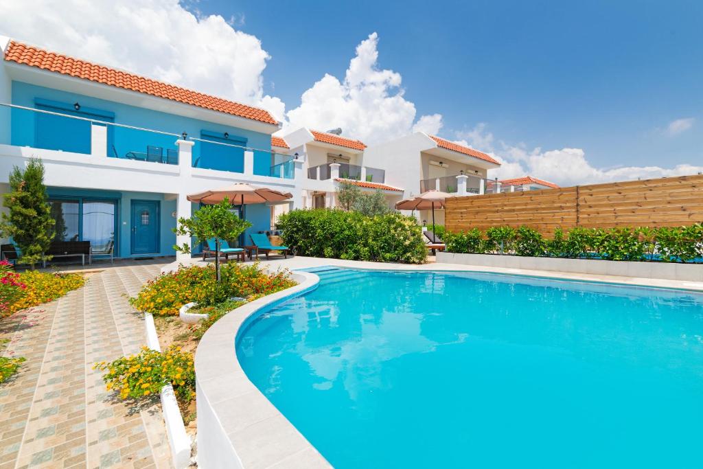 an image of a villa with a swimming pool at Kolymbia Village in Kolymbia