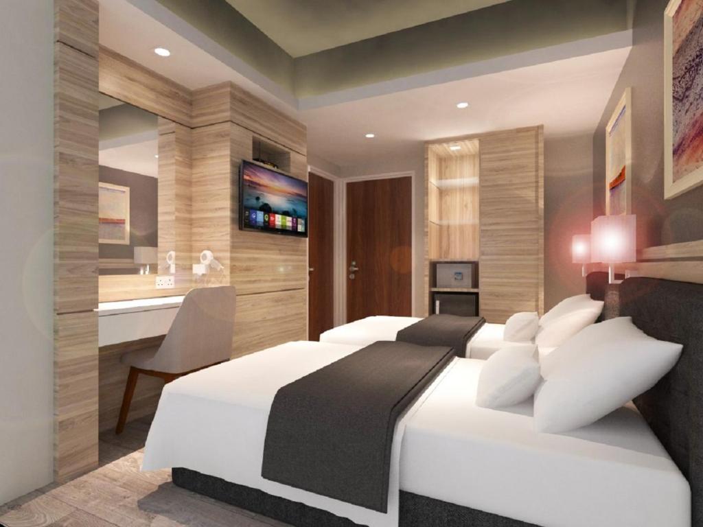 Postel nebo postele na pokoji v ubytování Grand Hallmark Hotel - Johor Bahru