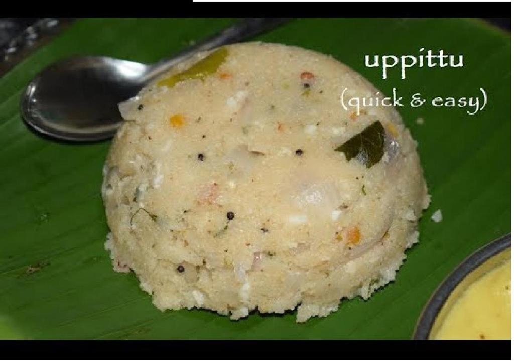 a green plate with a ball of rice and a spoon at Rks Homestay in Hampi